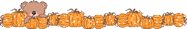 Bear hiding behind pumpkins
